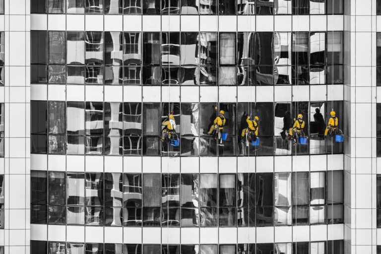 Professionelle Reinigung von Glasflächen an einem modernen Gebäude